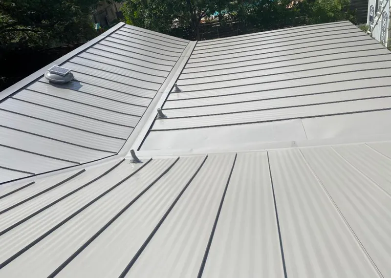 Solar attic fan installed on a metal roof for Roof Ventilation in Solon